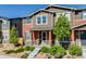 Inviting two-story home with landscaped front yard and covered porch entry at 13711 Ash Cir, Thornton, CO 80602