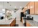 Modern kitchen featuring stainless appliances, granite counters, and breakfast bar seating at 13711 Ash Cir, Thornton, CO 80602