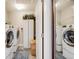 The laundry room with washer and dryer includes shelving and storage space at 13711 Ash Cir, Thornton, CO 80602