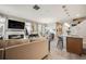 Open-concept living area with fireplace, dining space, and kitchen island seating at 13711 Ash Cir, Thornton, CO 80602