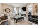 Comfortable living room featuring a modern fireplace, plush seating, and stylish decor at 13711 Ash Cir, Thornton, CO 80602