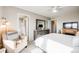 Serene main bedroom with sitting area, ceiling fan, and ensuite bathroom access at 13711 Ash Cir, Thornton, CO 80602