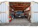 Well organized garage with a truck parked inside, and shelving at 14798 N 115Th St, Longmont, CO 80504