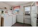 Laundry room equipped with modern washer and dryer, convenient shelving, and easy outside access at 14798 N 115Th St, Longmont, CO 80504