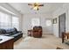 Cozy living room featuring plush seating, soft carpet, and natural light from large windows at 14798 N 115Th St, Longmont, CO 80504