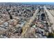 An aerial view features a densely populated neighborhood with varied house styles and tree coverage at 3180 S Albion St, Denver, CO 80222