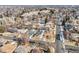 An aerial view of a neighborhood showcases tree-lined streets and various single-Gathering homes at 3180 S Albion St, Denver, CO 80222