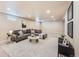 Inviting finished basement with plush sectional sofa, area rug, and modern decor at 3180 S Albion St, Denver, CO 80222
