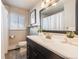 Classic bathroom featuring a dark vanity, framed mirror, and neutral walls at 3180 S Albion St, Denver, CO 80222