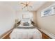 Inviting bedroom with a cozy bed, hardwood floors, stylish light fixture, and natural light at 3180 S Albion St, Denver, CO 80222
