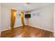 Comfortable bedroom with hardwood floors, neutral walls, bright windows, and stylish window treatments at 3180 S Albion St, Denver, CO 80222
