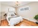 Inviting bedroom with hardwood floors, stylish lighting, and a cozy bed with decorative pillows at 3180 S Albion St, Denver, CO 80222
