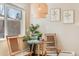 Charming breakfast nook featuring a glass-top table, woven chairs, and a stylish pendant light fixture at 3180 S Albion St, Denver, CO 80222