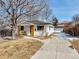 Charming home with a well-maintained front yard, a long driveway and beautiful curb appeal at 3180 S Albion St, Denver, CO 80222