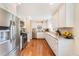 Bright kitchen with stainless steel appliances, granite countertops, and stylish white cabinetry at 3180 S Albion St, Denver, CO 80222