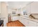 Bright kitchen featuring stainless steel appliances, granite countertops, and white cabinetry at 3180 S Albion St, Denver, CO 80222