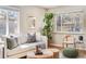 Inviting living room with decorative throw pillows and plants by the window at 3180 S Albion St, Denver, CO 80222
