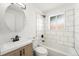 Modern bathroom with a sleek vanity and a combined shower-tub at 3581 Olive St, Denver, CO 80207