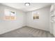 Bright bedroom with two windows and gray carpet at 3581 Olive St, Denver, CO 80207