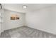 Sunny bedroom featuring cozy carpet and large window at 3581 Olive St, Denver, CO 80207