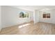 Inviting living room with wood floors, natural light, and views of the front yard at 3581 Olive St, Denver, CO 80207