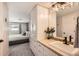 Bathroom with built-in vanity providing access to the main bedroom at 3842 S Quebec St, Denver, CO 80237