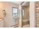 Modern bathroom featuring glass enclosed shower and window, offering a bright and clean feel at 3842 S Quebec St, Denver, CO 80237