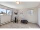 Bright bedroom featuring exercise equipment, natural light, and a cozy area for fitness activities at 3842 S Quebec St, Denver, CO 80237