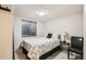 Cozy bedroom featuring a twin bed, stylish bedding, and a simple bedside table with soft lighting at 3842 S Quebec St, Denver, CO 80237