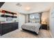 Cozy bedroom featuring a dresser, a double bed, closet space, and a large window at 3842 S Quebec St, Denver, CO 80237