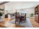 Elegant dining room with hardwood floors, modern lighting, and adjacent kitchen area for easy entertaining at 3842 S Quebec St, Denver, CO 80237