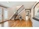 Grand entryway with hardwood floors, staircase, and decorative sculpture feature for a stylish home welcome at 3842 S Quebec St, Denver, CO 80237