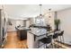 Modern kitchen with sleek countertops, stainless steel appliances, and a breakfast bar for casual dining at 3842 S Quebec St, Denver, CO 80237