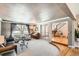 Inviting living room with a piano, large window, staircase and tasteful decor creates a warm atmosphere at 3842 S Quebec St, Denver, CO 80237