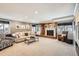 Cozy living room features a brick fireplace, plush seating, and natural light from the windows at 3842 S Quebec St, Denver, CO 80237