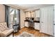 Home office nook featuring built-in cabinets, desk space, hardwood floors, and a comfortable chair at 3842 S Quebec St, Denver, CO 80237