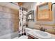 Bathroom featuring tiled shower, vanity with sink, and wooden accents at 25704 Shiloh, Conifer, CO 80433