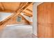 Bright bedroom with a log-beam ceiling, neutral carpet, and a window providing natural light at 25704 Shiloh, Conifer, CO 80433