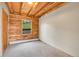 Cozy bedroom features log walls, natural light from the window, and neutral carpet at 25704 Shiloh, Conifer, CO 80433