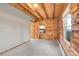 Bedroom with log walls and a view of the lush greenery outside at 25704 Shiloh, Conifer, CO 80433