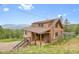 Charming log home with a spacious porch and scenic mountain views at 25704 Shiloh, Conifer, CO 80433