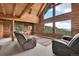 A spacious living area with log walls and high ceilings, featuring comfortable seating and a scenic view at 25704 Shiloh, Conifer, CO 80433