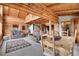 A comfortable living space featuring a dining table and couches in a beautiful log cabin at 25704 Shiloh, Conifer, CO 80433