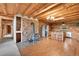 Open layout featuring a wood burning stove, stone accent wall, stainless steel fridge and dining area at 25704 Shiloh, Conifer, CO 80433