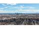 Expansive aerial view of the city skyline, with neighborhoods and a cloudy sky in the foreground at 7818 Florado St, Denver, CO 80221