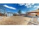 Spacious backyard featuring a shed, covered patio, and potential for landscaping at 7818 Florado St, Denver, CO 80221