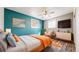 Bright bedroom features an accent wall, plush rug, and natural light from a window at 7818 Florado St, Denver, CO 80221