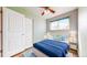 Cozy bedroom featuring light walls, a ceiling fan, light blue accents, and a bright window at 7818 Florado St, Denver, CO 80221