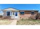 Charming front exterior featuring a bay window, brick accents, and a well-manicured lawn at 7818 Florado St, Denver, CO 80221