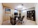 Home office featuring wood paneled walls, bright windows, a large desk and ample storage at 7818 Florado St, Denver, CO 80221